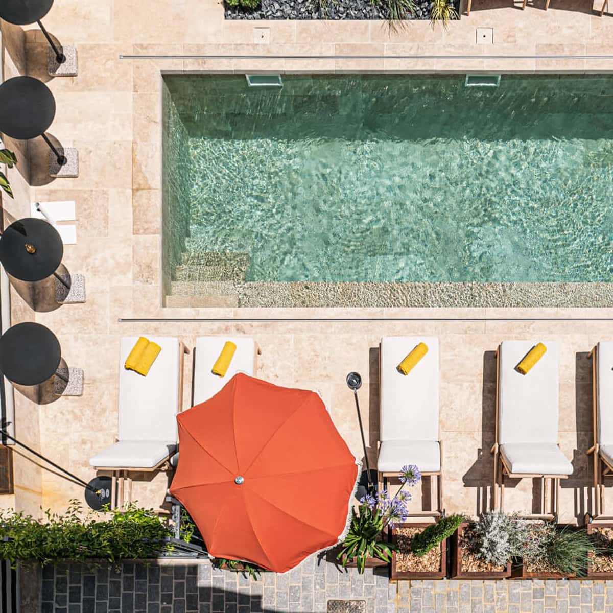 Aerial view of Hotel Mosaique pool in Narbonne, showing the water and relaxation area.